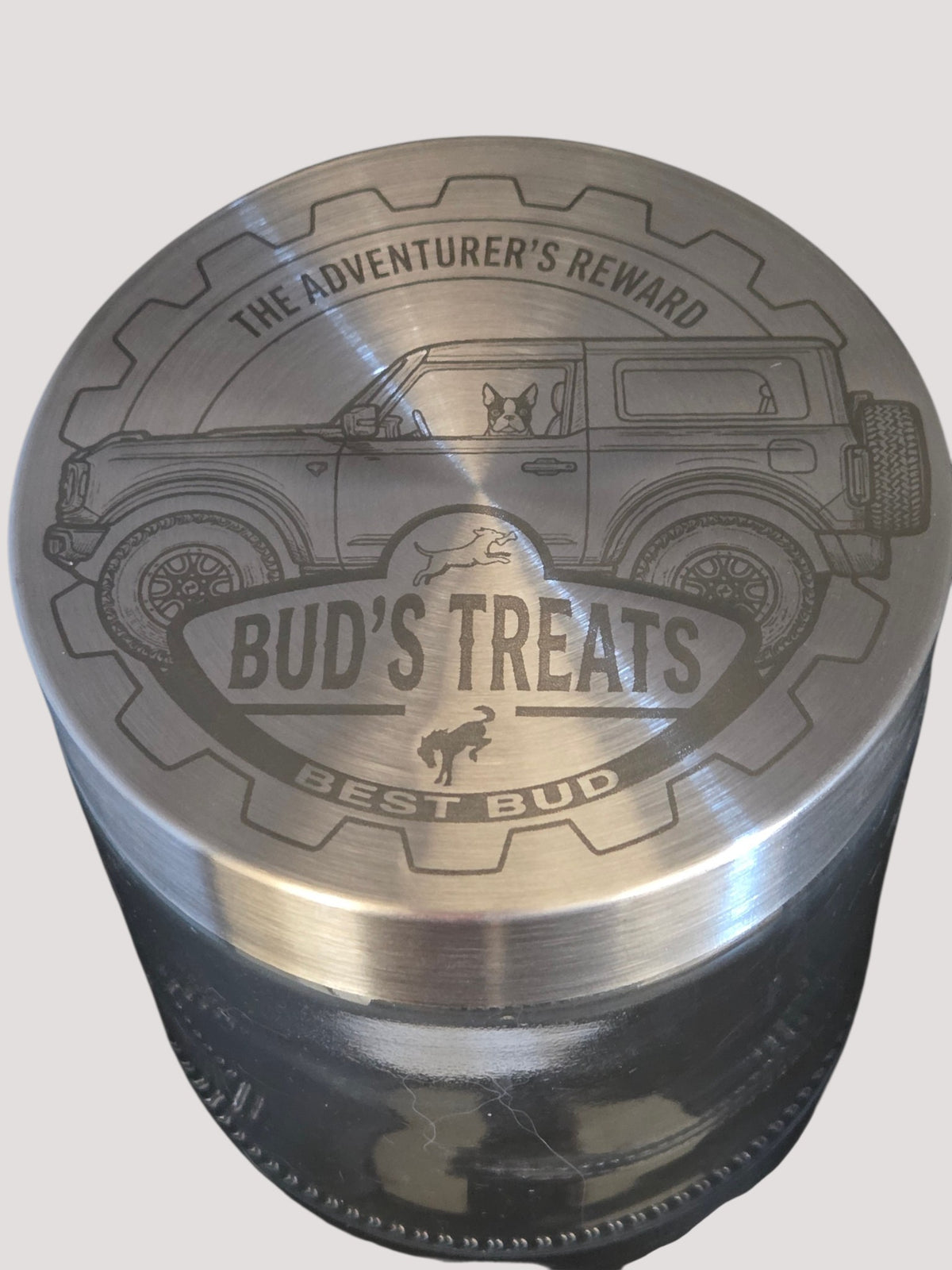 L & P Golden goods custom glass storage jar with a laser-engraved stainless steel lid featuring a dog and car design.