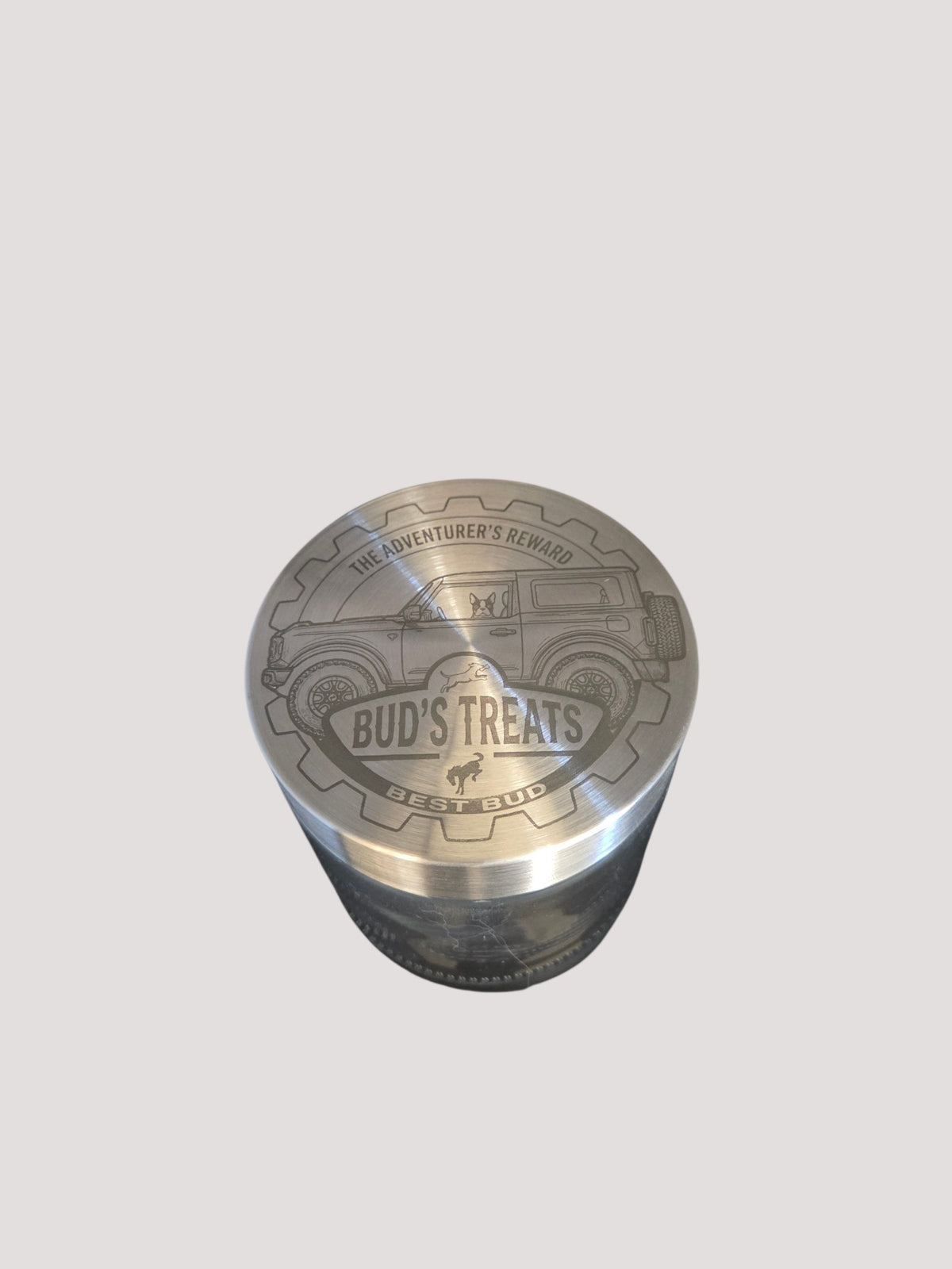 L & P Golden goods custom glass storage jar with a laser-engraved stainless steel lid featuring a car and dog design.