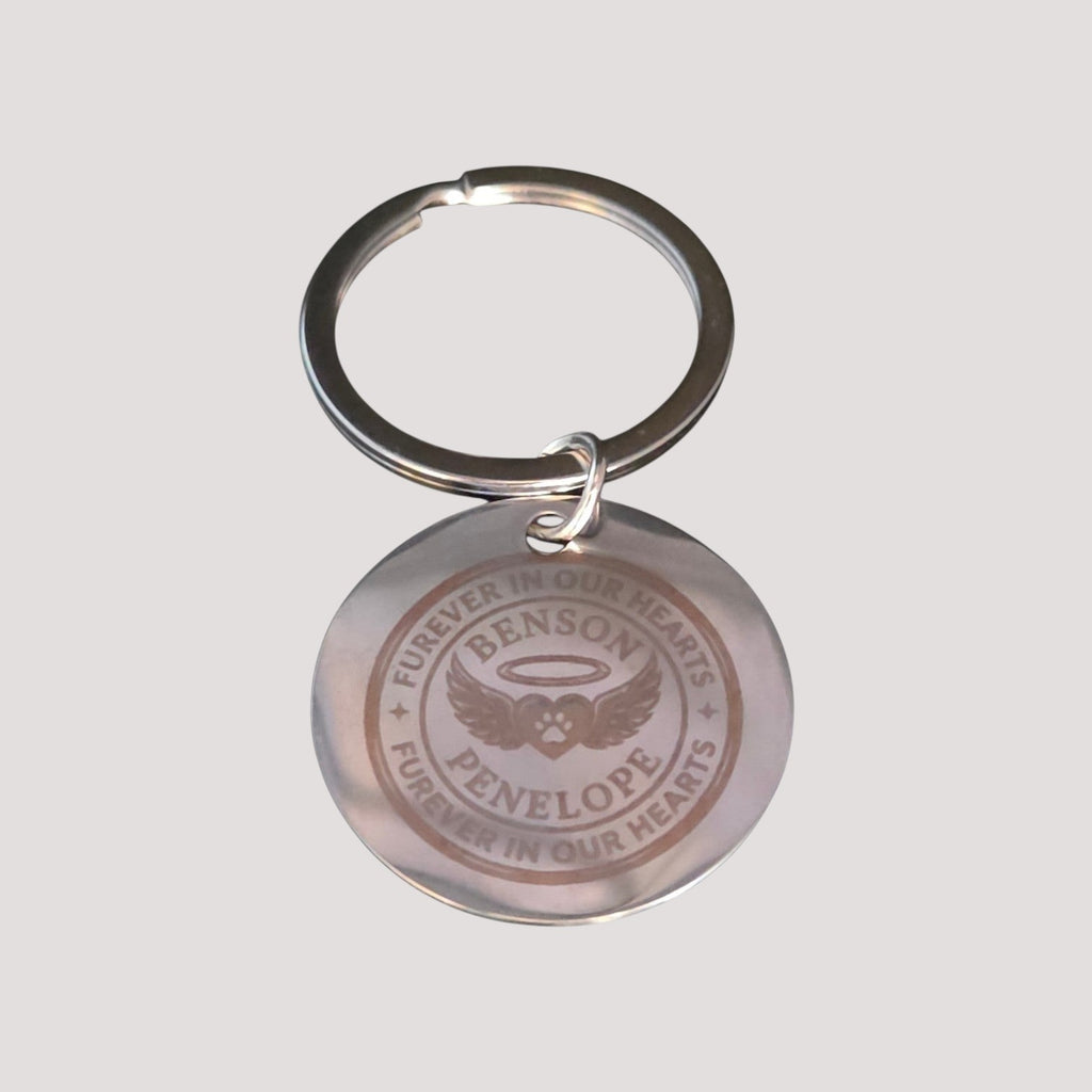L & P Golden goods round stainless steel keychain with custom laser-engraved memorial text and angel wings design.
